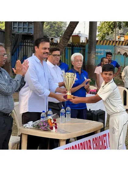The captain, Yuvraj Mali, proudly receiving the Vengsarkar Cup trophy on behalf of the team.