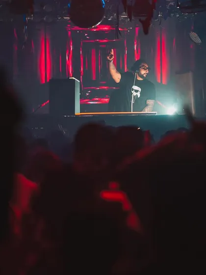 A silhouette shot from the DJ booth, overlooking a sea of hands in the air. This is the result I strive for: a completely captivated audience.