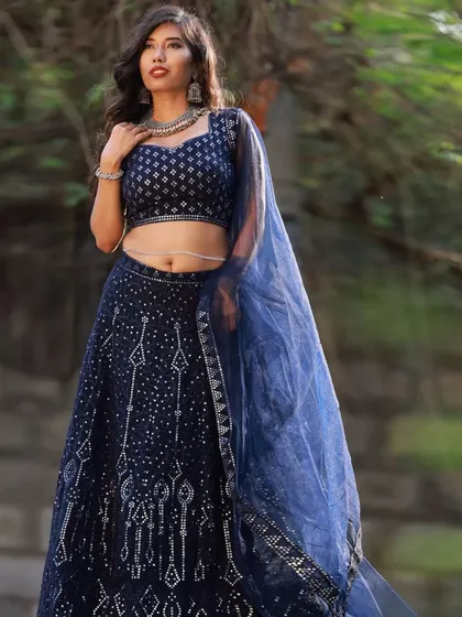 This pose shows the flow and movement of the lehenga and dupatta. It's a great way to capture the full essence of an outfit during an outdoor fashion collaboration.