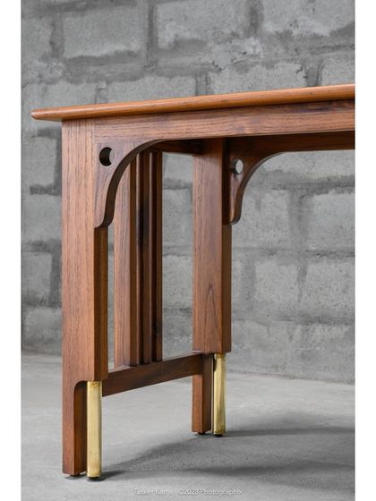 Introducing the Madhu Study Table, a statement of discerning aesthetics and master craftsmanship. The harmonious blend of solid teak and brass accents makes it a versatile addition to any interior style.