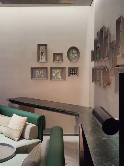 An angled view of the framed painting installation, highlighting the custom 3D frames that add another layer to the artwork.