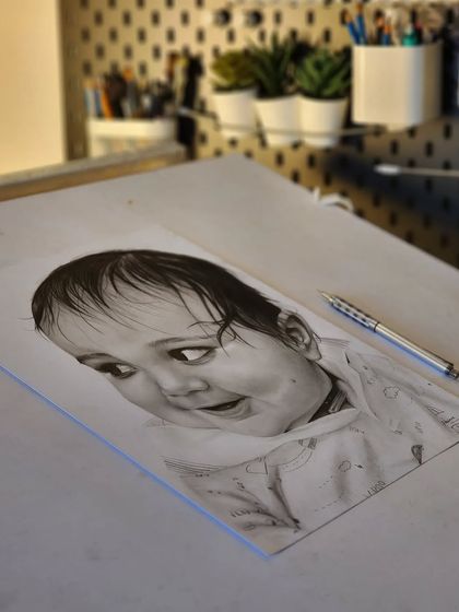 Another view of the baby portrait on my drawing table.