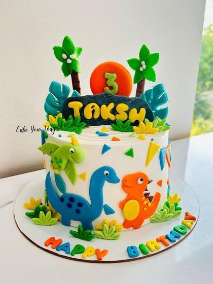 Roaring into a third birthday with this dino-mite cake, featuring cute and colorful fondant dinosaurs.