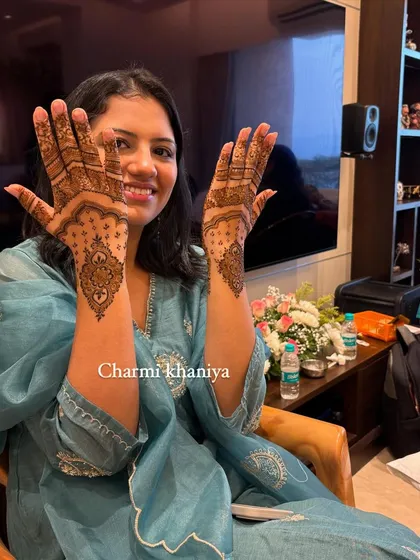 A beautiful client with her elegant back-of-hand mehendi. Her smile says it all!