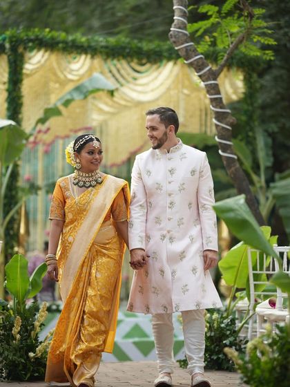 The happy couple walking hand in hand after their ceremony. The joy on their faces is the ultimate reward for creating a wedding day that perfectly tells their story.