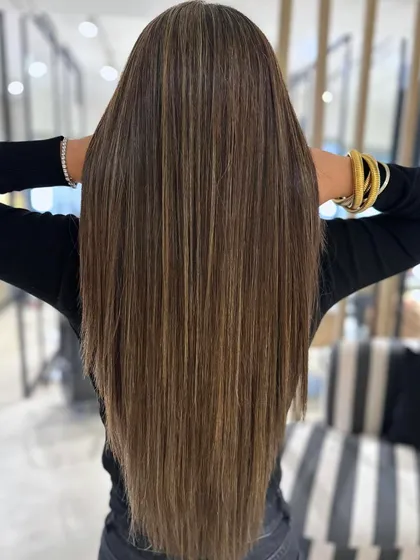 A cool blonde highlight blend styled perfectly straight to showcase the precision of the color. The back-to-back foil technique ensures a seamless and high-impact result on long hair.