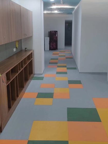Colorful vinyl flooring installed in a hallway. This material is strong, water resistant, and ideal for schools, hospitals, or commercial areas that need to be cleaned often.
