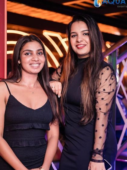 Two friends enjoying the Elegance night at The Fixx Bar. It's a great place for a stylish weekend outing.