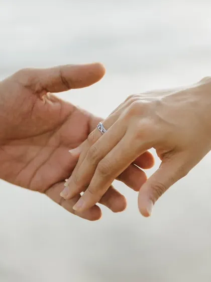A simple, elegant photograph focusing on the promise of forever. This close-up of the engagement ring is a classic shot that symbolizes the beginning of your new journey together.