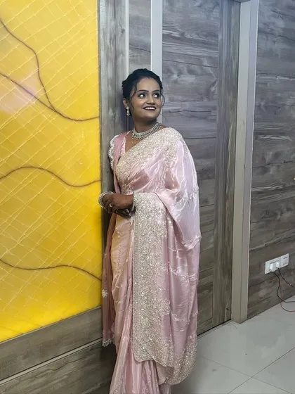 A full shot of the bride against a vibrant background. The makeup stands out beautifully without looking heavy.