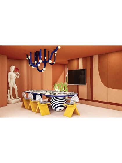 A wide shot of the dining area, showing how the combination of classic art, modern furniture, and bold colors creates a truly unique and memorable experience.