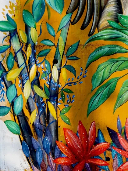 Intricate leaves and branches that create the lush jungle environment of the mural.