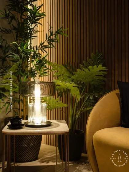 A close-up of our crystal and glass table lamp, highlighting the ribbed glass texture that beautifully diffuses the light, creating a warm and sophisticated glow.