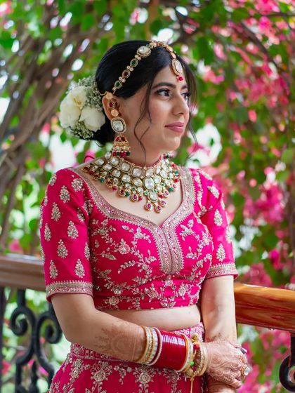 A similar frame to the previous one, this portrait captures the bride's elegance and the beauty of her floral surroundings.