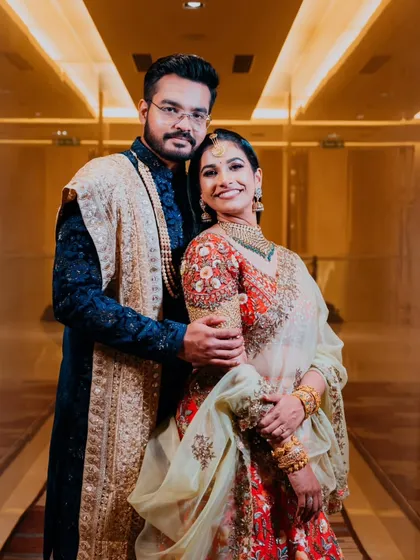 A classic couple portrait from their reception, showcasing their stunning outfits and the happy glow of newlyweds.