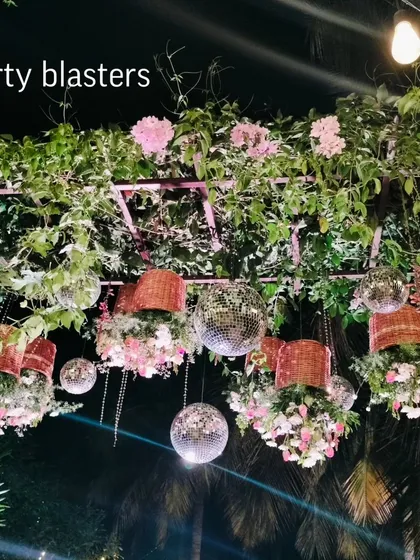 I love creating fusion looks that mix different styles. Here, we hung disco balls alongside fresh flowers and woven baskets from a canopy of green vines, creating a magical, starlit effect for an evening reception.