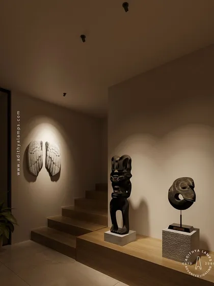 Our nearly invisible recessed spotlights create a gallery-like feel in this hallway. The focused light beautifully accentuates the angel wings wall sculpture and the tribal statues, demonstrating how minimal fixtures can produce maximum impact.
