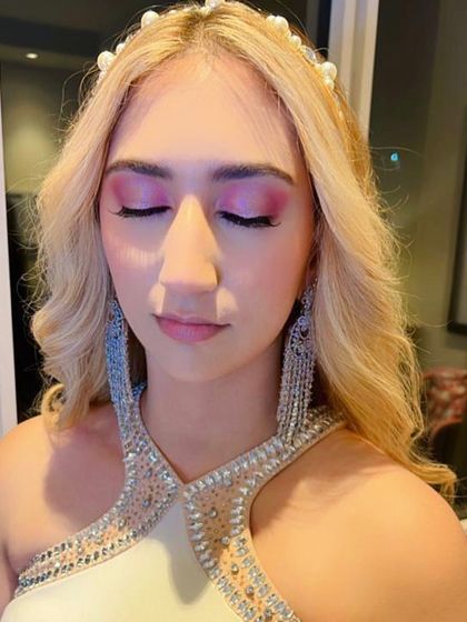 Fun and colorful unicorn-inspired eye makeup. Using shades of pink and purple, this look is playful and perfect for a themed party or for a client who loves to experiment with color.