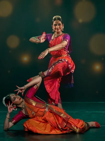 Crafting duet choreography is about creating a dialogue between two dancers. This pose captures a moment of interaction and shared energy, reflecting a style that emphasizes partnership and complementary movement in performance.