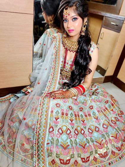 This light blue lehenga is covered in colorful geometric and floral embroidery. It’s a very unique and modern bridal choice, perfect for making a memorable statement.