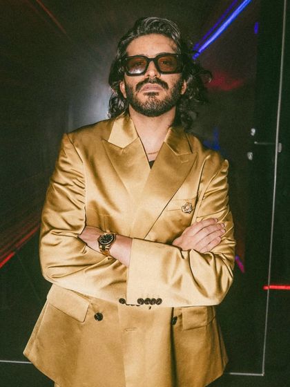 Actor Harshvarrdhan Kapoor styled by our team for an H&M event. His long hair is given a natural, textured look that complements his high-fashion gold suit.