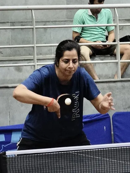A veteran player demonstrates her skill and precision during a match in the Indian Table Tennis League.