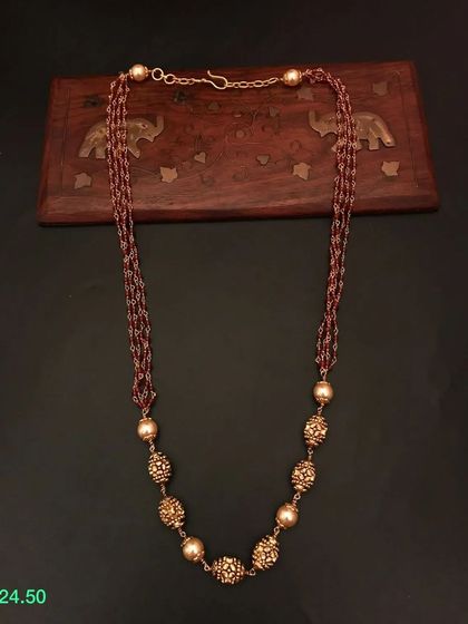 This multi-strand necklace features a beautiful combination of brown beads and ornate golden beads. It's a unique and earthy-toned piece from my 92.5 silver collection.