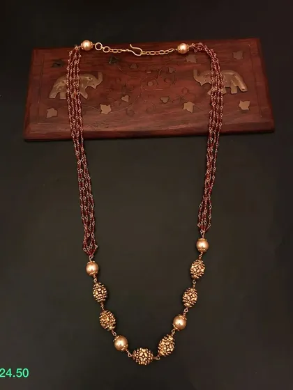 This multi-strand necklace features a beautiful combination of brown beads and ornate golden beads. It's a unique and earthy-toned piece from my 92.5 silver collection.