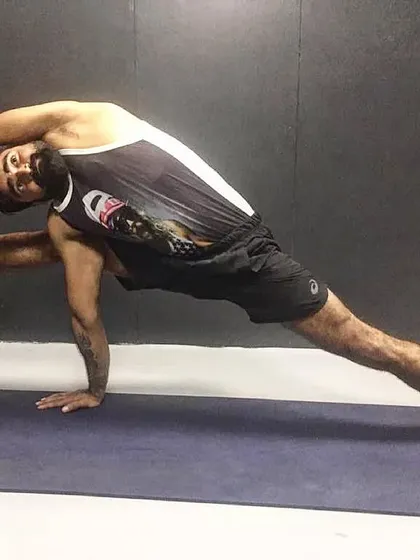 Using a wall as a prop can help deepen stretches and explore new ranges of motion. Here, I am performing an advanced variation of Vasisthasana (Side Plank Pose) to intensely stretch the side body, hamstrings, and hips.