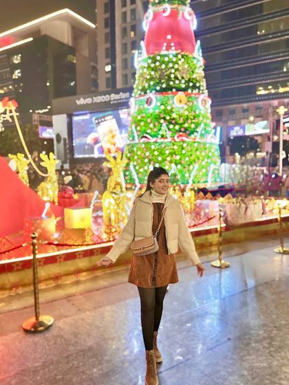 Feeling the festive spirit with this Christmas look. I've layered a puffer vest over a corduroy dress and tights for a cozy and chic outfit perfect for a night out enjoying the holiday lights.