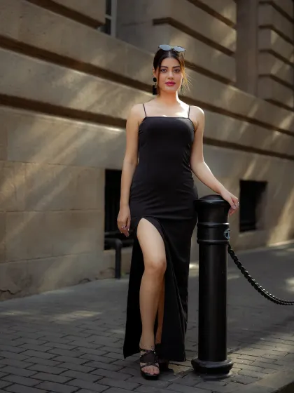 A full-length view of the elegant black dress against a classic stone building, showing how I frame shots to include architectural elements.