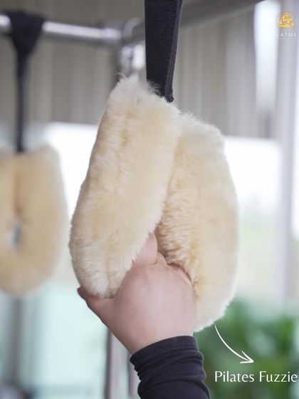 The 'fuzzies' or hanging straps on the Cadillac are used for a variety of exercises that challenge the upper body and core, including pull-ups and hanging stretches.