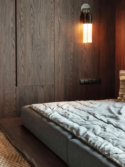 A cozy 'gadda-bed' in the daughter's lounge, perfect for sleepovers or quiet reading. The room is paneled in dark wood, creating a warm, den-like atmosphere.