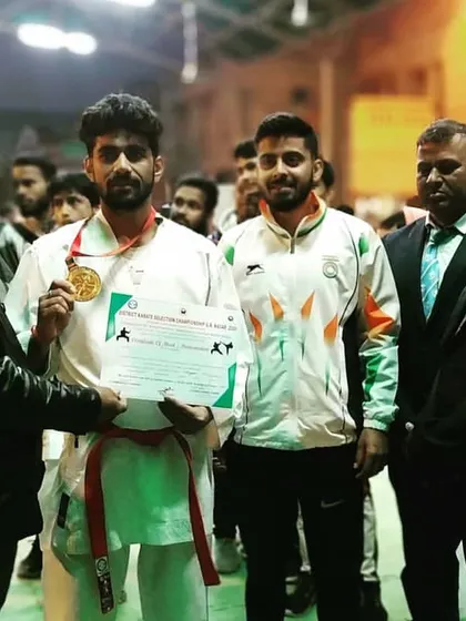 One of my senior students receiving his gold medal and certificate from officials after winning his category. His achievement is an inspiration to the entire team.
