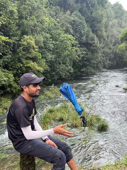 A fun, creative shot of our trek lead's umbrella seemingly floating by the river on the Kurinjal trail.
