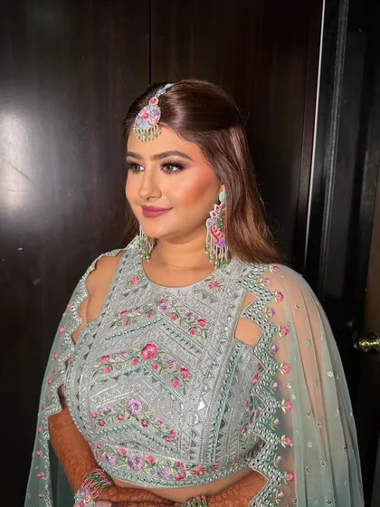 A side profile of Riddhi, showing the beautiful details of her makeup and hair.