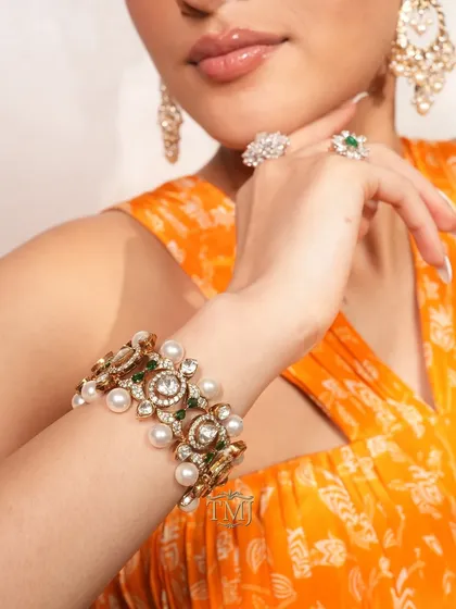 In frame: a stunning polki and pearl bracelet that doubles up as a choker, paired with pearl chandbalis and diamond rings for a complete festive look.