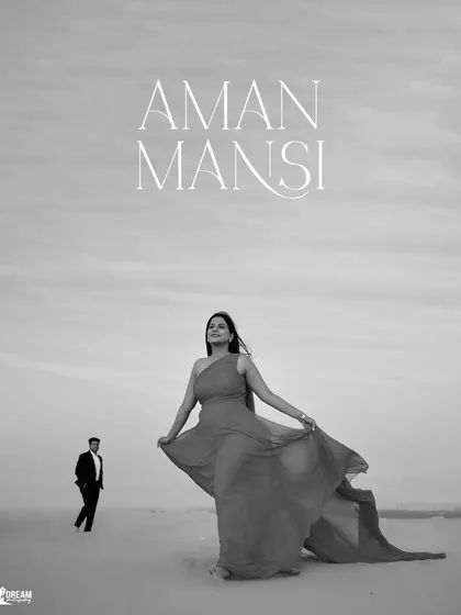 A powerful black and white portrait in the desert. The composition emphasizes the bride's confident pose and the endless expanse of the dunes.