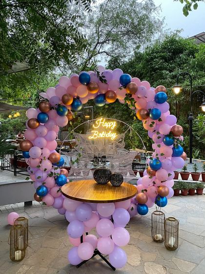 A full view of the outdoor birthday ring setup, complete with a cake table and lanterns.