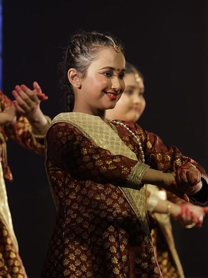The smiles of our young dancers as they perform together at Varshik Utsav 2024, reflecting their enjoyment of the art.