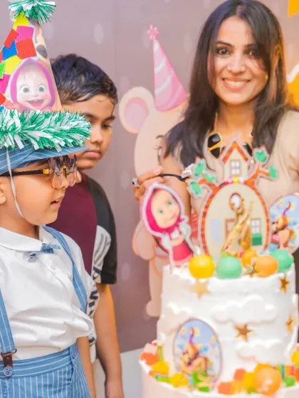 A Masha and the Bear themed party, complete with a detailed cake and a very happy birthday boy in his party hat. We love bringing cartoon favorites to life.