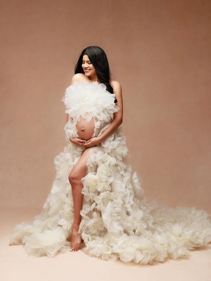 A joyful and candid moment in the beautiful white floral gown, showing off its unique texture and playful spirit.