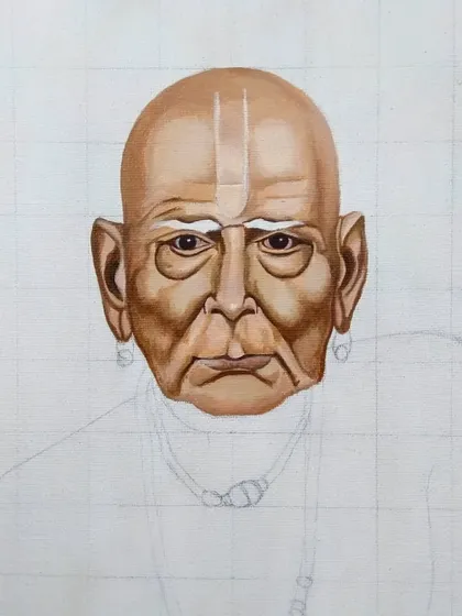 Here, I'm adding the tilak and building up the skin tones on the forehead. Each step involves carefully blending acrylics to create a smooth, realistic gradient.
