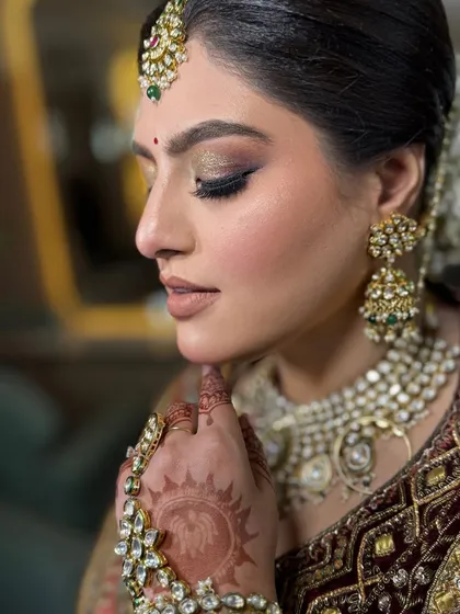 A close-up of this bride's beautiful makeup. We opted for a bronze and gold shimmery eye to complement her deep maroon velvet lehenga, creating a rich and royal look.