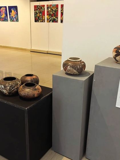 A collection of my pit-fired ceramic pots on display at the "Setu" art exhibition. The varied shapes and unique surface markings from the firing process make each one an individual piece of art.