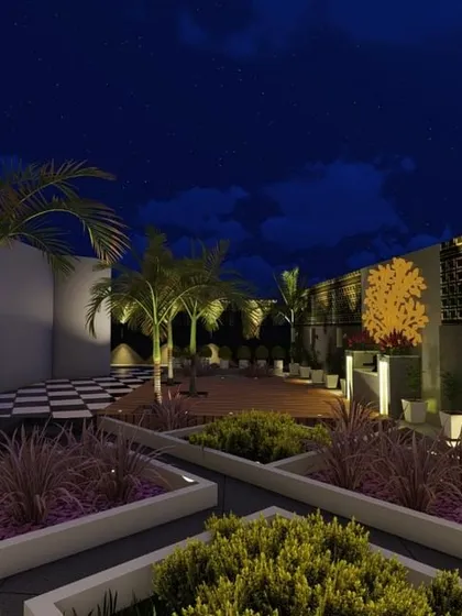 A night view of a terrace with geometric planters and a beautifully lit feature wall. The strategic use of uplighting and backlighting creates a sophisticated and modern aesthetic.