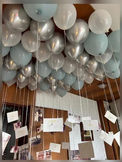 A sentimental and personal touch for a 40th birthday. We filled the ceiling with balloons, each with a cherished photo hanging from its string, creating a beautiful canopy of memories for the birthday person and their guests.