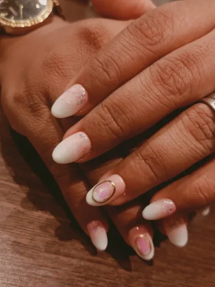 A closer view of the baby ombre nails, showing the seamless blend and the delicate gold ring detail on the accent nail.