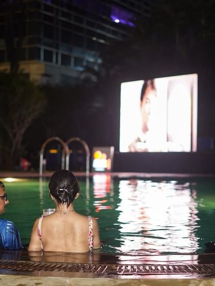 A group of friends enjoying our Dive-in Cinema screening. It's a fantastic way to hang out, cool off, and watch a great film together.