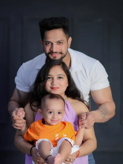 A creative pose for a family of three. This tiered arrangement is a fun way to create a visually interesting and connected family portrait.